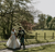 newlyweds duncan and allie walking in traditional scottish wedding clothes 