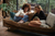 couple browsing through phone on the sofa