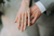 Couples hands displaying their wedding bands 