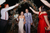 newlyweds walking down the aisle under a floral archway 