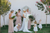 bride surrounded by her bridesmaids and flower girls