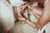 Bridesmaids helps bride to put on her wedding shoes