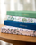 a stack of journals on a wooden table