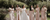 bride walking down a stone path with her bridesmaids