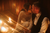 newlyweds kissing in a candlelit room