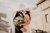 newlyweds first kiss with bride holding rose bouquet