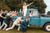 Wedding guests push a truck with bride and groom during their relaxed marquee wedding 