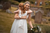 Bride hugs a flower girl outside the church