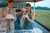 Groom and bride in apron are trying to make a pizza
