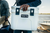 A man brings a white Yeti cooler to the beach