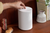 Hand presses button on Sonos speaker