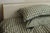 Bed made with gingham bed linen