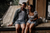 Couple sits on the edge of their lake house enjoying wedding gifts from Prezola