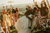Bride and groom kiss after their destination wedding ceremony while the guests are cheering behind