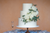 three tiered white wedding cake with white roses and greenery