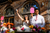 Newlyweds at top table cheering with bright coloured flowers