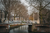 two women walking across a little bridge in the netherlands 