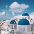 a blue and white town facing the sea in santorini 