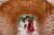 bride and groom kissing under a stone cave