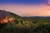 a man sitting on the edge of a hut in the middle of a forest in south africa