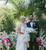 photo of newlyweds with plants in the background 