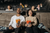 a couple holding popcorn and watching a movie in a cinema 