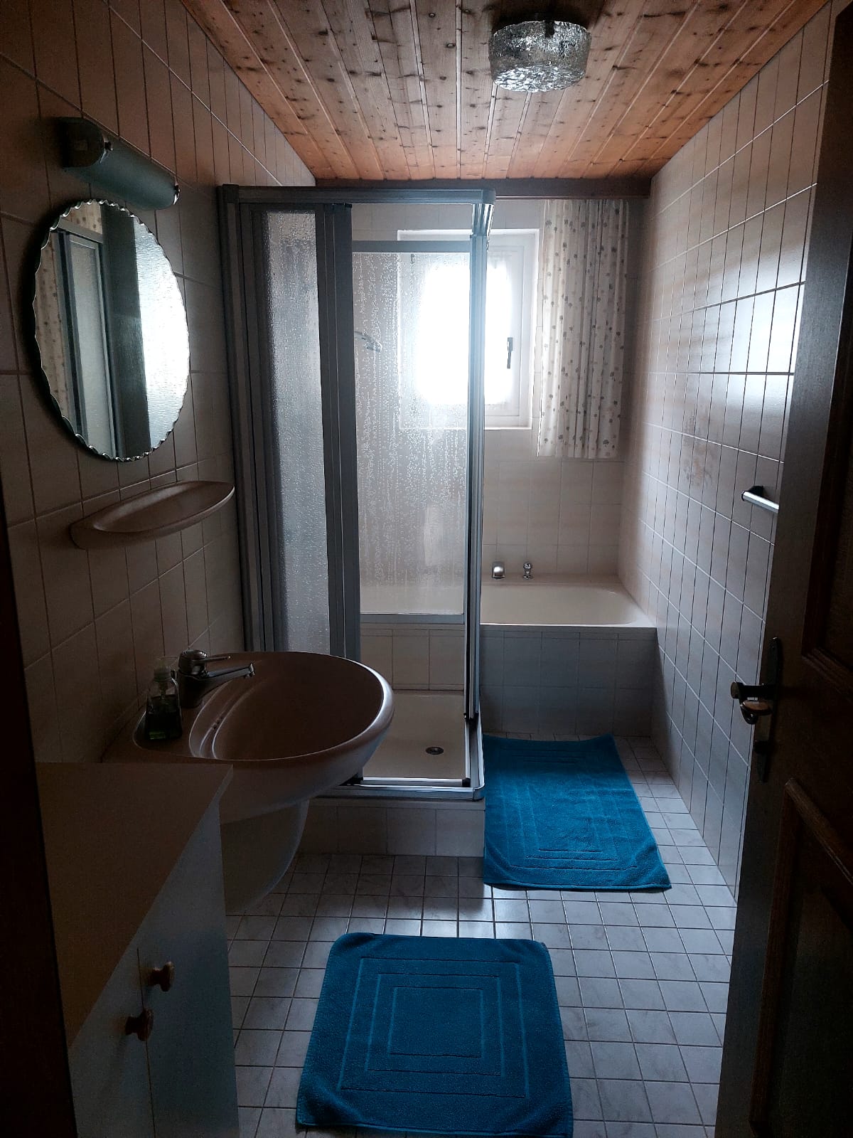 Bathroom with shower and bath. Small sink with mirror