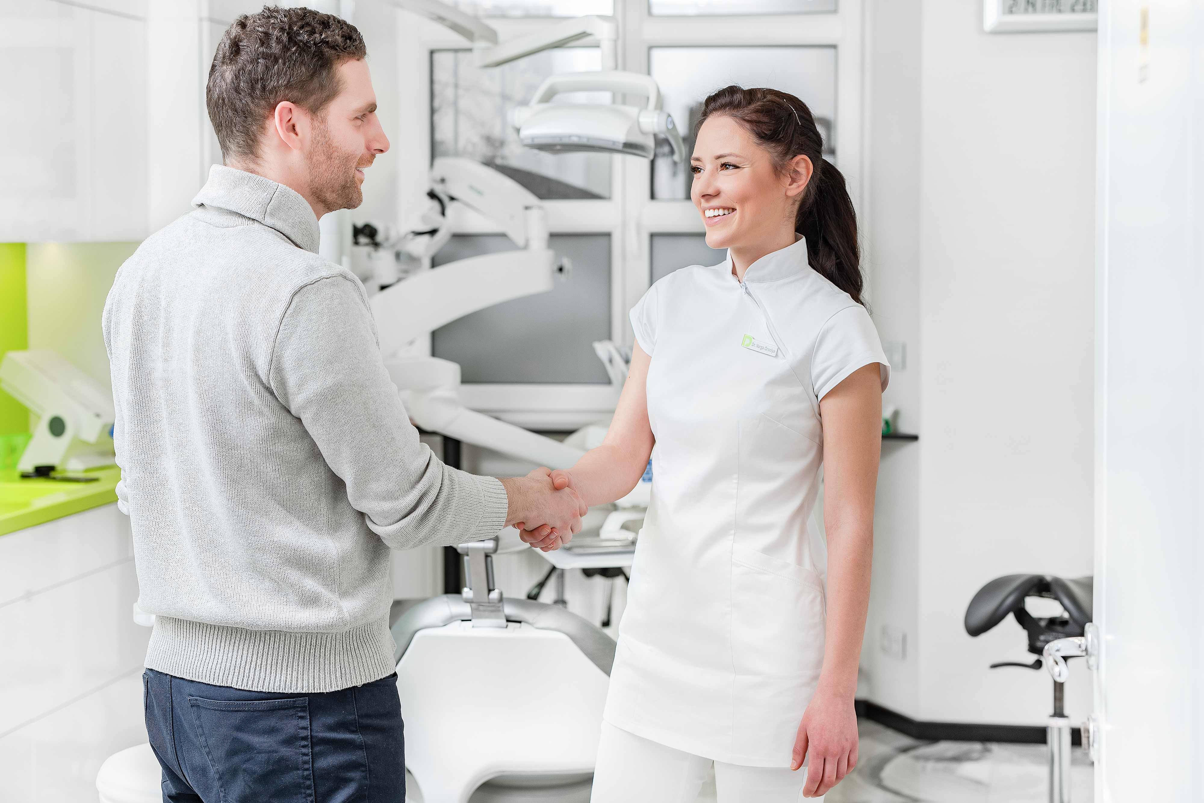Dr. Orsolya Varga, a dentist, greets the patient with a handshake at Potidental Dental Clinic Debrecen.