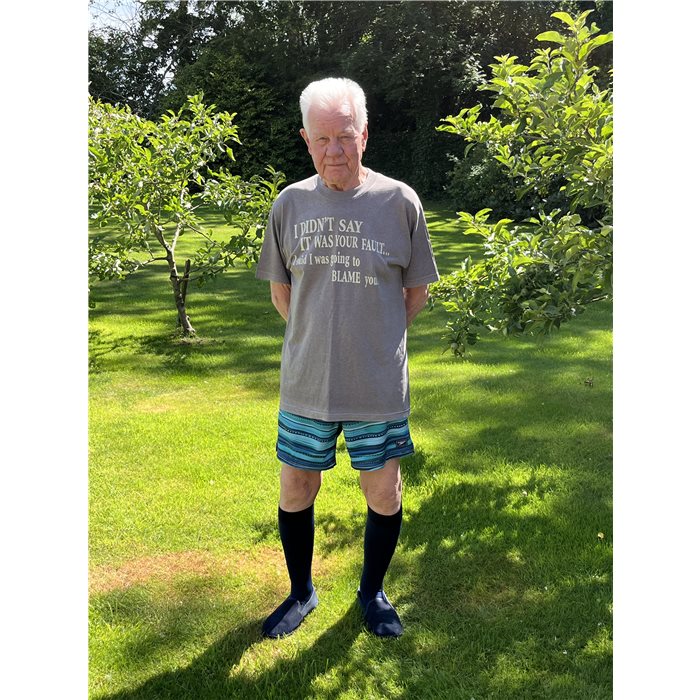 Tony standing on his garden lawn in navy compression