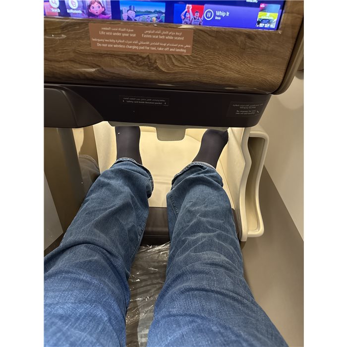 Compression stockings resting on an aeroplane footrest