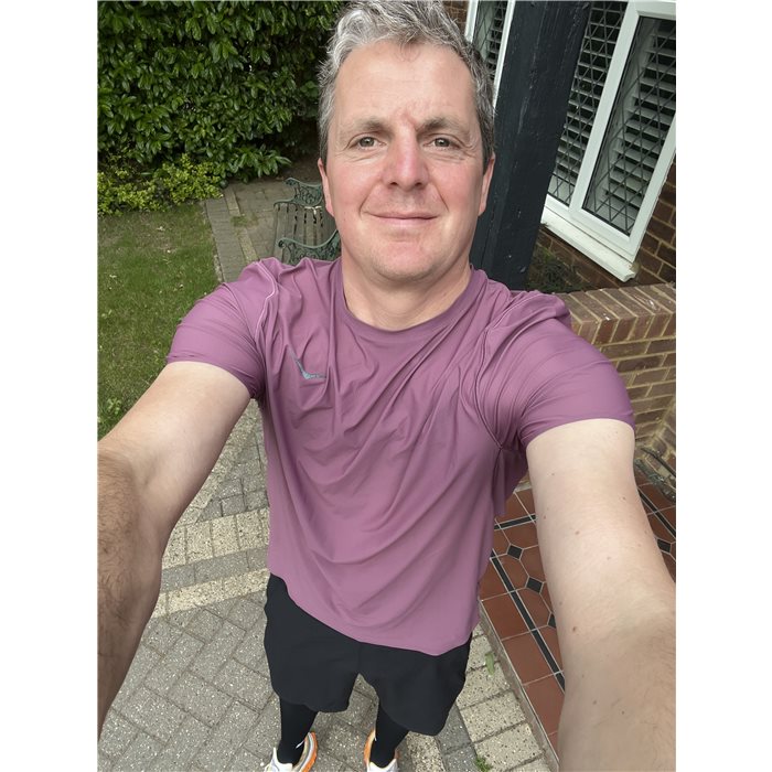 Liam smiling outside his front door after a run