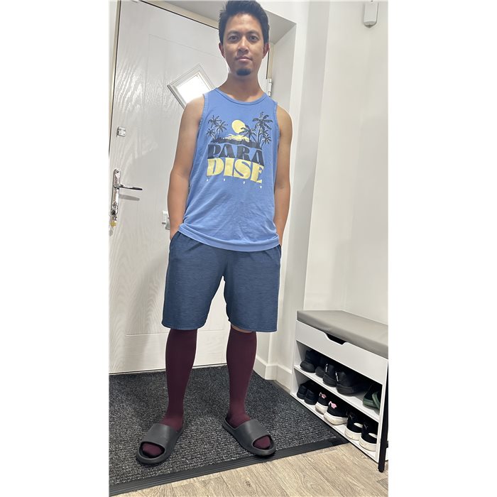 Mart in the hallway wearing burgundy compression socks