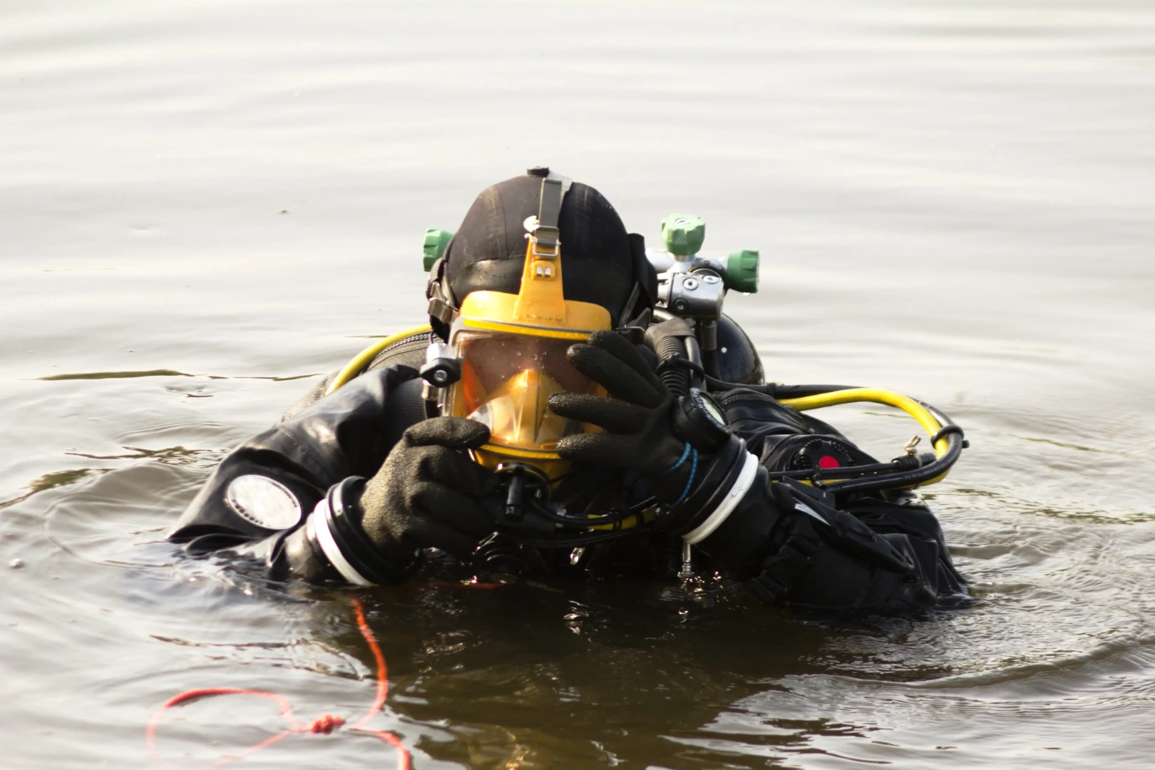 Diver coming out of the water with a full face mask equipment