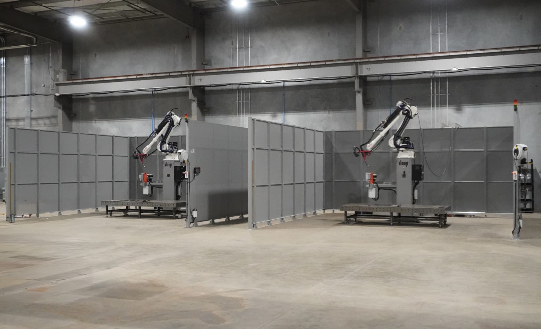 Two WAAM robots in individual cells.