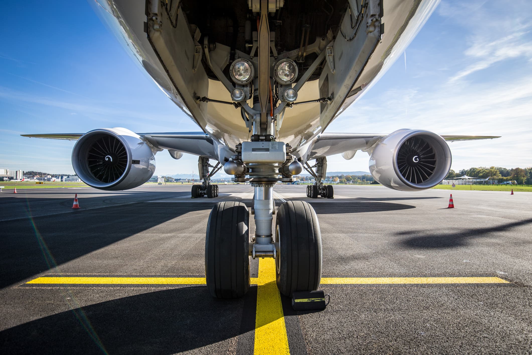 A photo of the underside front of an aircraft, displaying the landing gear. 