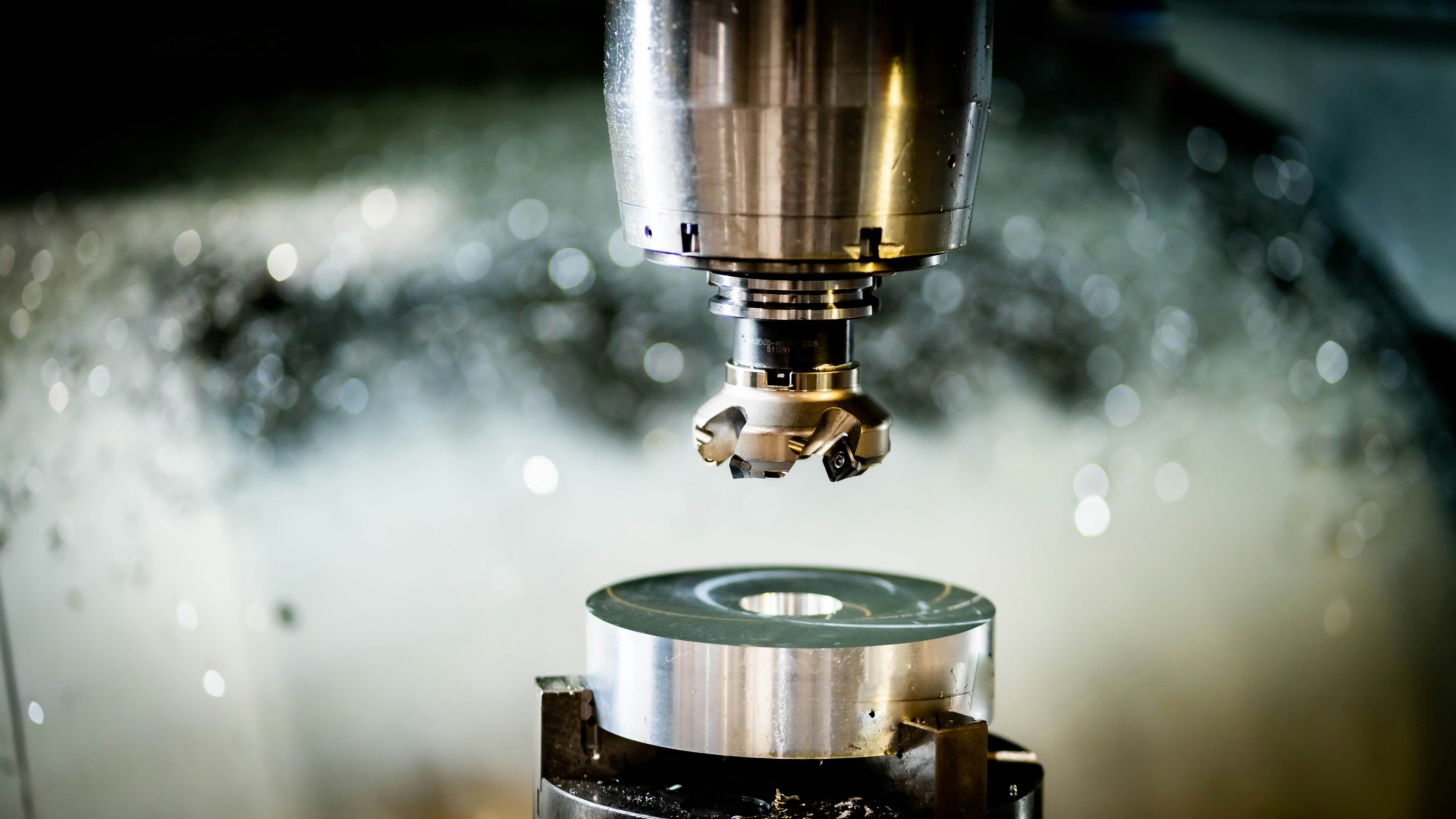 A close up of a CNC machine working on a component