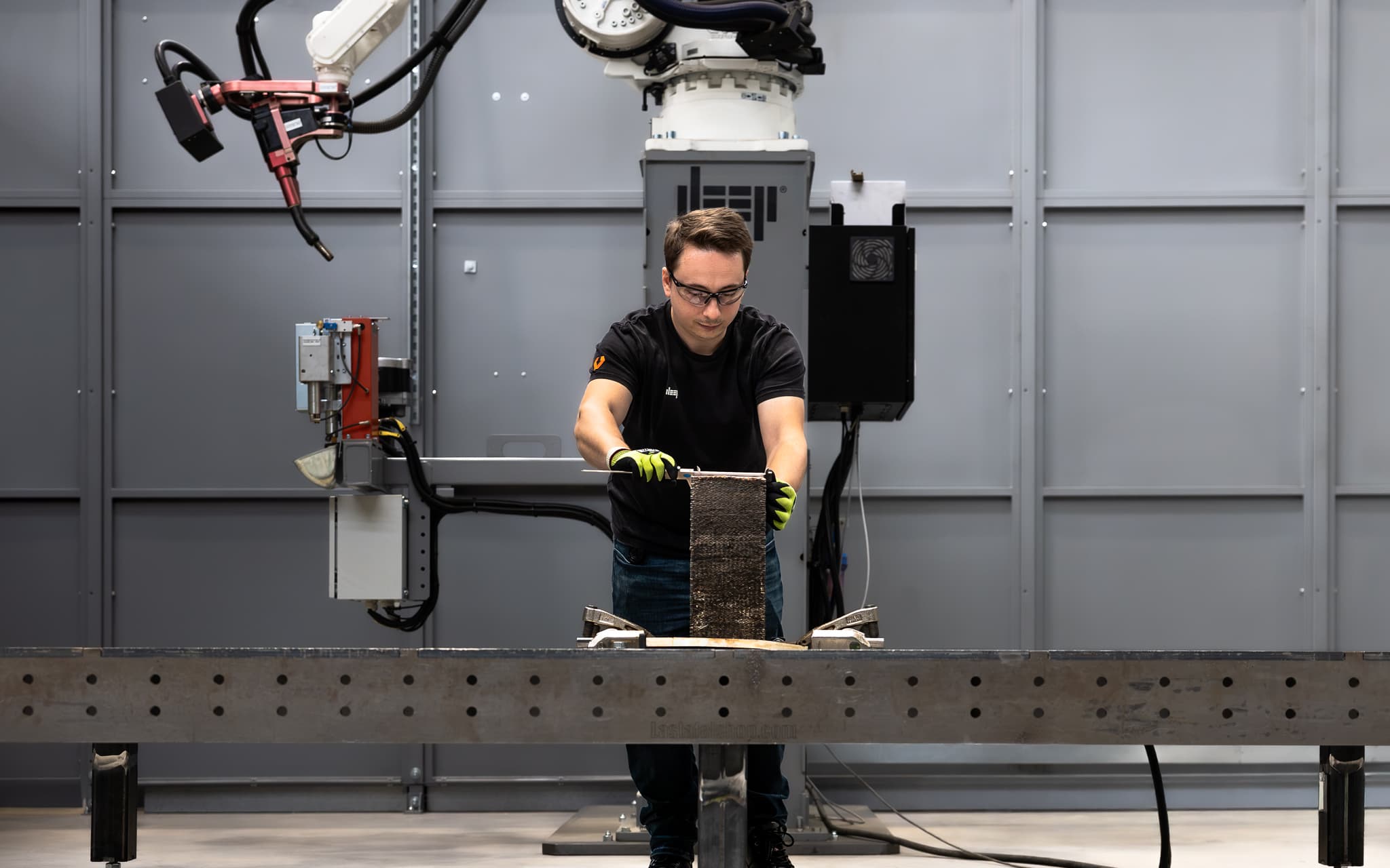 Engineer handling a WAAM test piece at DEEP Manufacturing