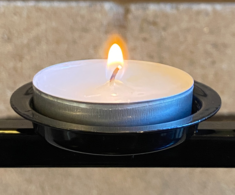 A lit votive candle burning at the St Boniface National Shrine